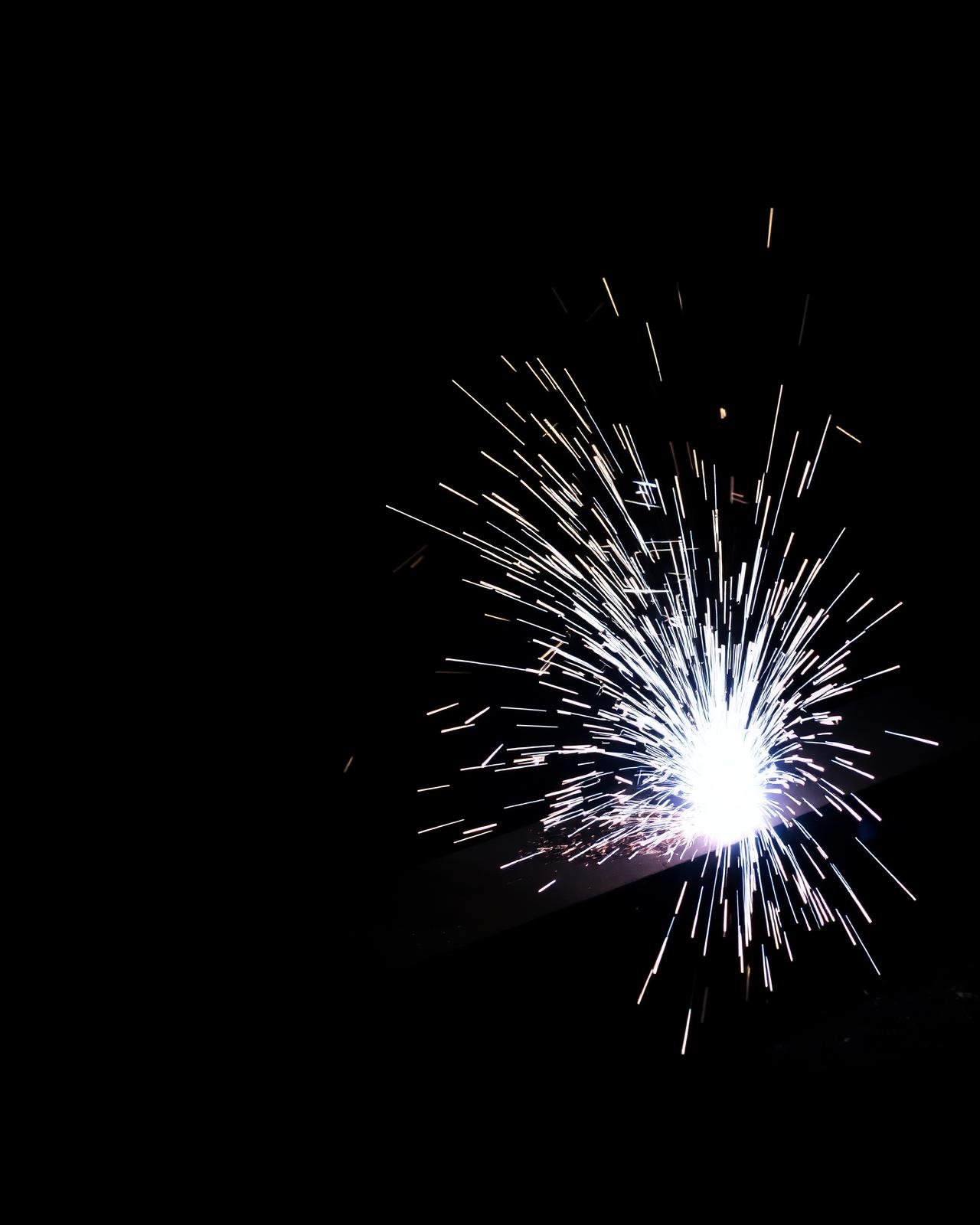 Industrial fiber laser cutting steel with sparks flying